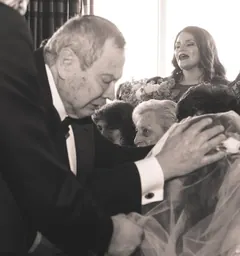 Opa blessing the bride at a family wedding, his hand on her veil