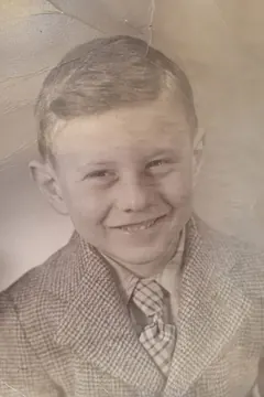 Opa as a boy in Newark, smiling in a tweed jacket